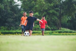 Kids playing soccer football