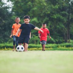 Kids playing soccer football